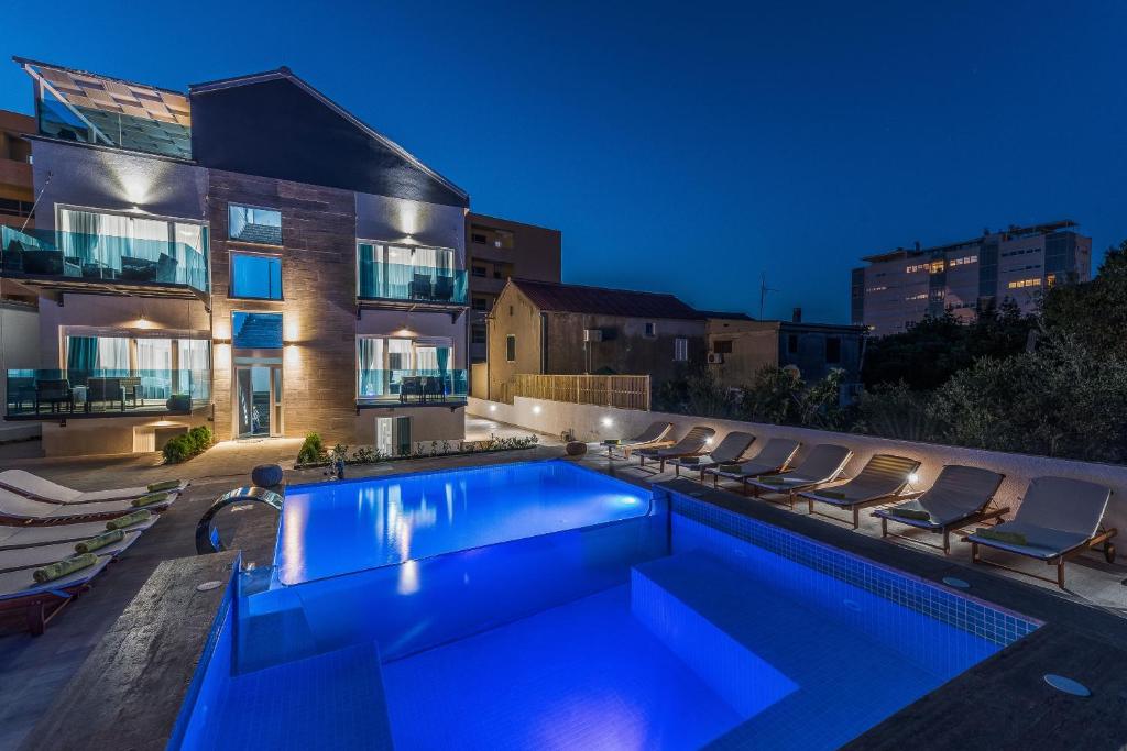 a swimming pool in the backyard of a house at Luxury Apartments Villa Morea in Zadar