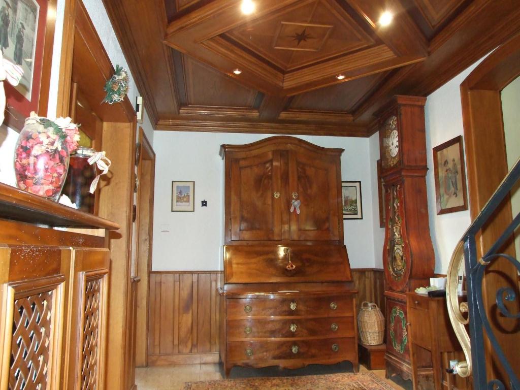 a room with a large wooden dresser in a room at Chambre d&#39;Hôtes &quot;Au Vigneron&quot; in Triembach-au-Val