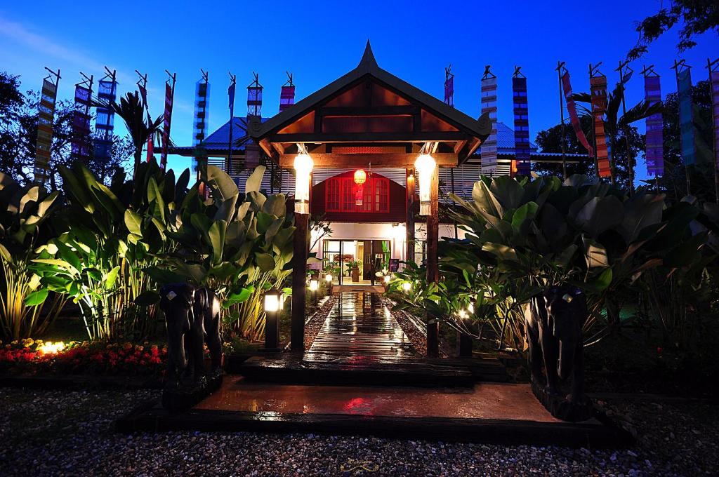 a building with lights in front of it at night at Risasinee Spa & Resort in Nan