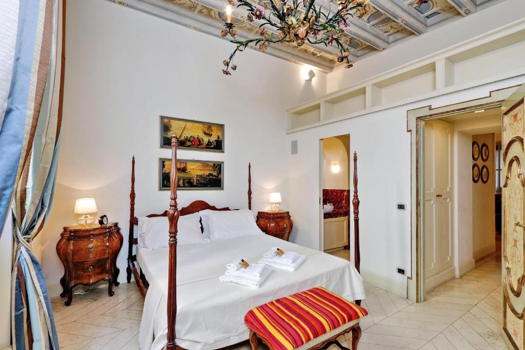 a bedroom with a large white bed and two chairs at Boccaccio 22 in Rome