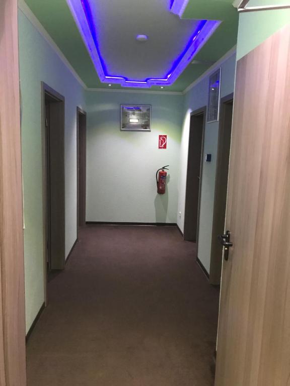 a hallway with a blue light on the ceiling at Hotel-Pension Alt-Heidenberg in Siegen