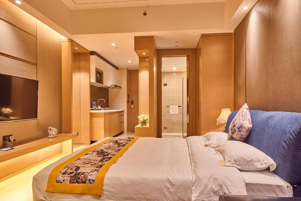 a bedroom with a large bed and a bathroom at Heefun International Apartment - Zhujiang New Town FuLi Brand New World Plaza in Guangzhou