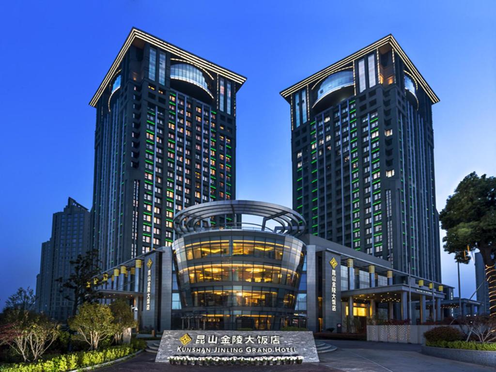 two tall buildings in a city at night at Kunshan Jinling Hotel in Kunshan