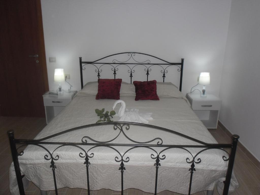 a bedroom with a large bed with red pillows at La casa di Donato in Palinuro