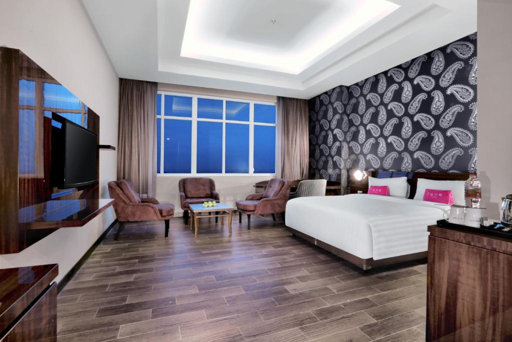 Postel nebo postele na pokoji v ubytování favehotel S. Parman Medan