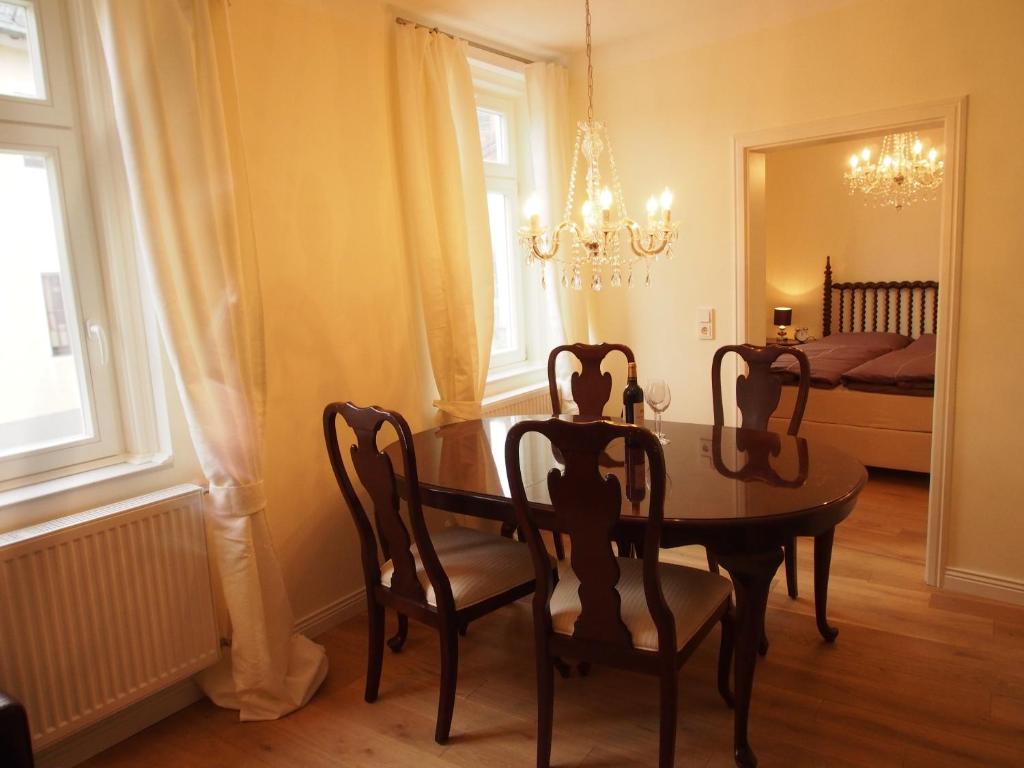 a dining room with a table and chairs and a bed at Luxus Residenz Königstein in Königstein im Taunus