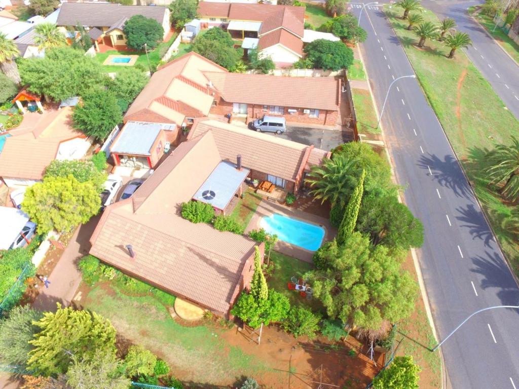 an overhead view of a house with a swimming pool at Cura Lodge in Bloemfontein