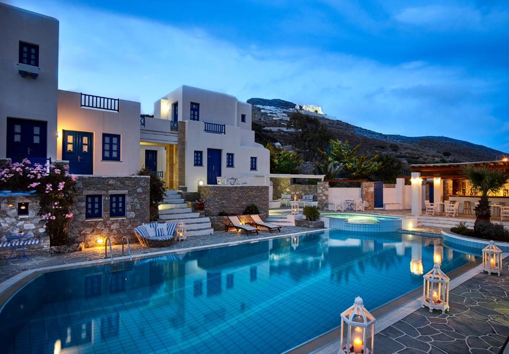 a villa with a swimming pool at night at Folegandros Apartments in Chora Folegandros