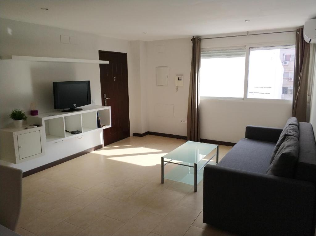 Televízia a/alebo spoločenská miestnosť v ubytovaní Apartamento Comedias