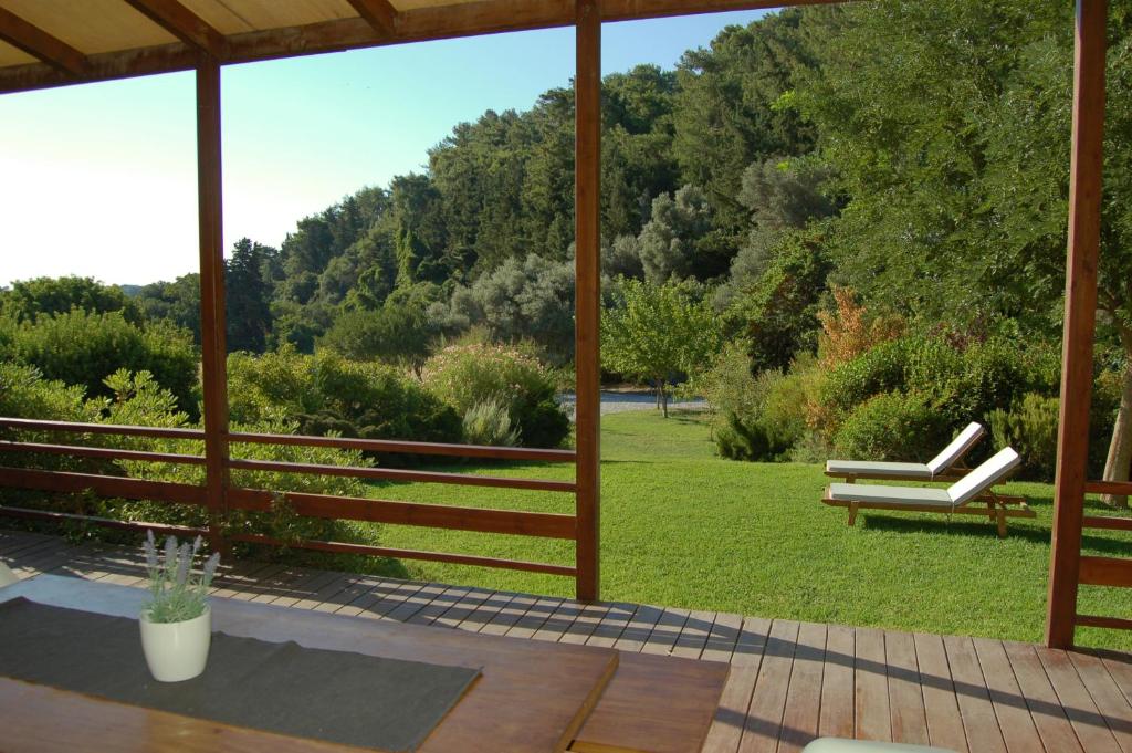 a porch with a bench and a view of a park at Serene retreat in Rhodes Town