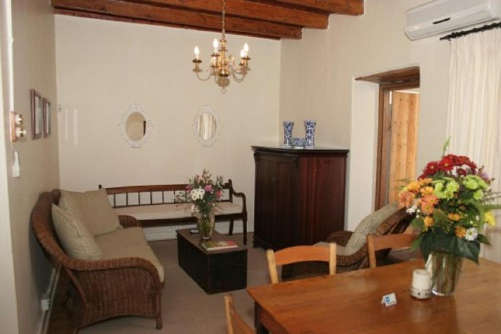 a living room with a couch and a table at De Kothuize 16 in Graaff-Reinet