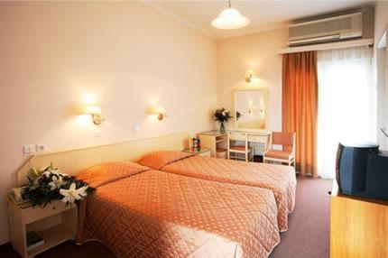 Postel nebo postele na pokoji v ubytování Palladion Hotel