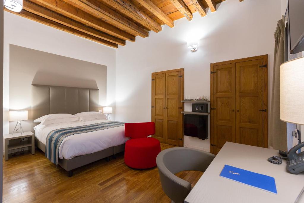 Postel nebo postele na pokoji v ubytování Ai Suma Hotel