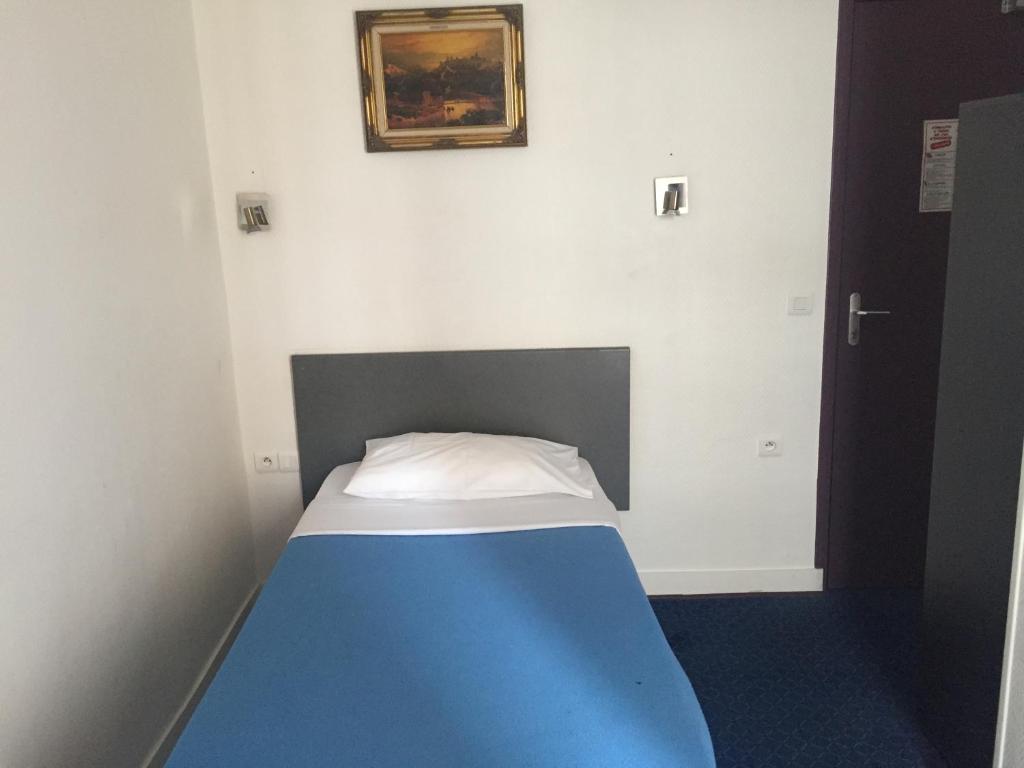 Postel nebo postele na pokoji v ubytování Hotel Chevallier