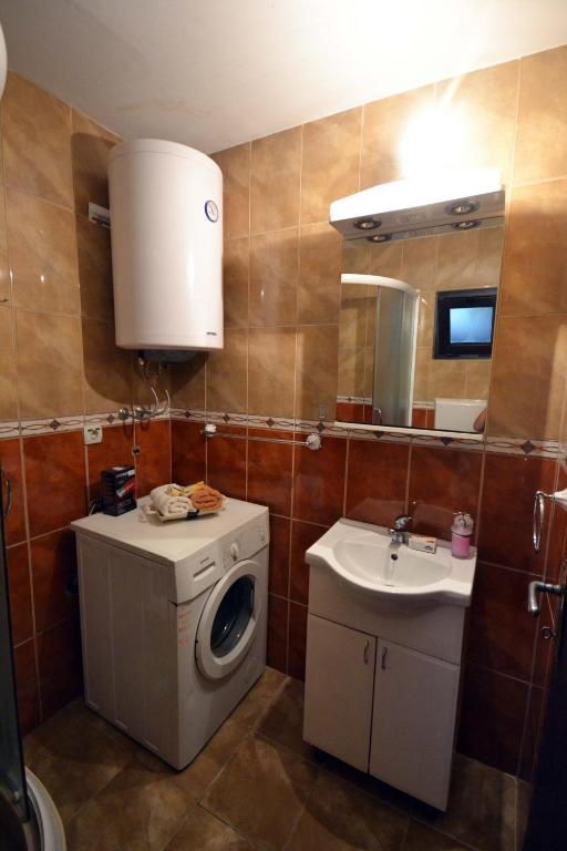 a bathroom with a washing machine and a sink at Apartments Dionis in Kotor