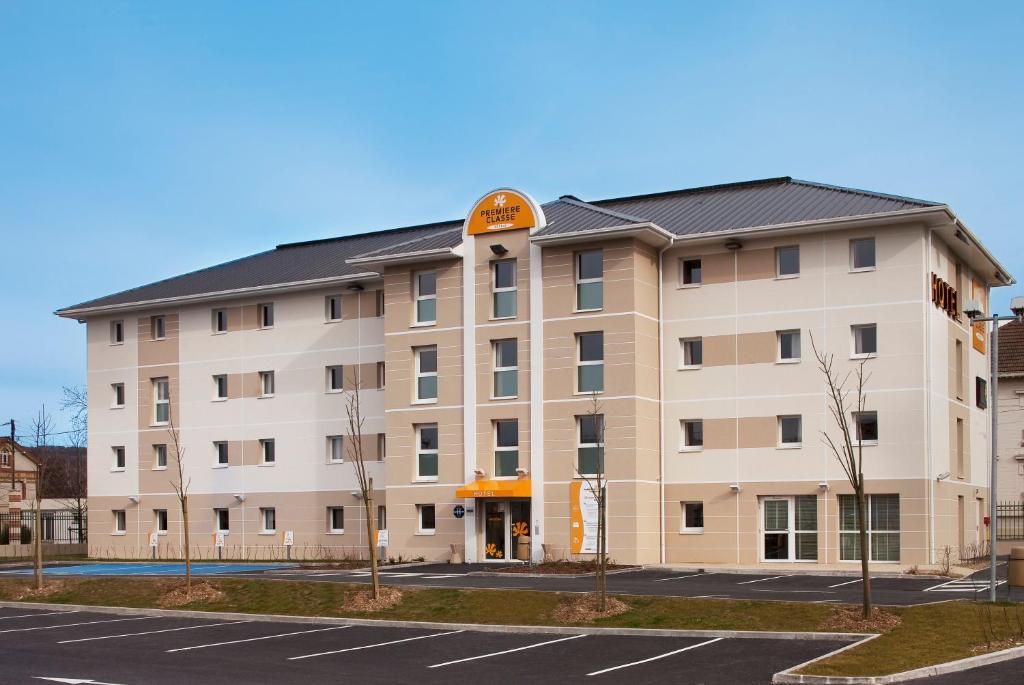 a large apartment building with a parking lot at Première Classe Epernay in Épernay