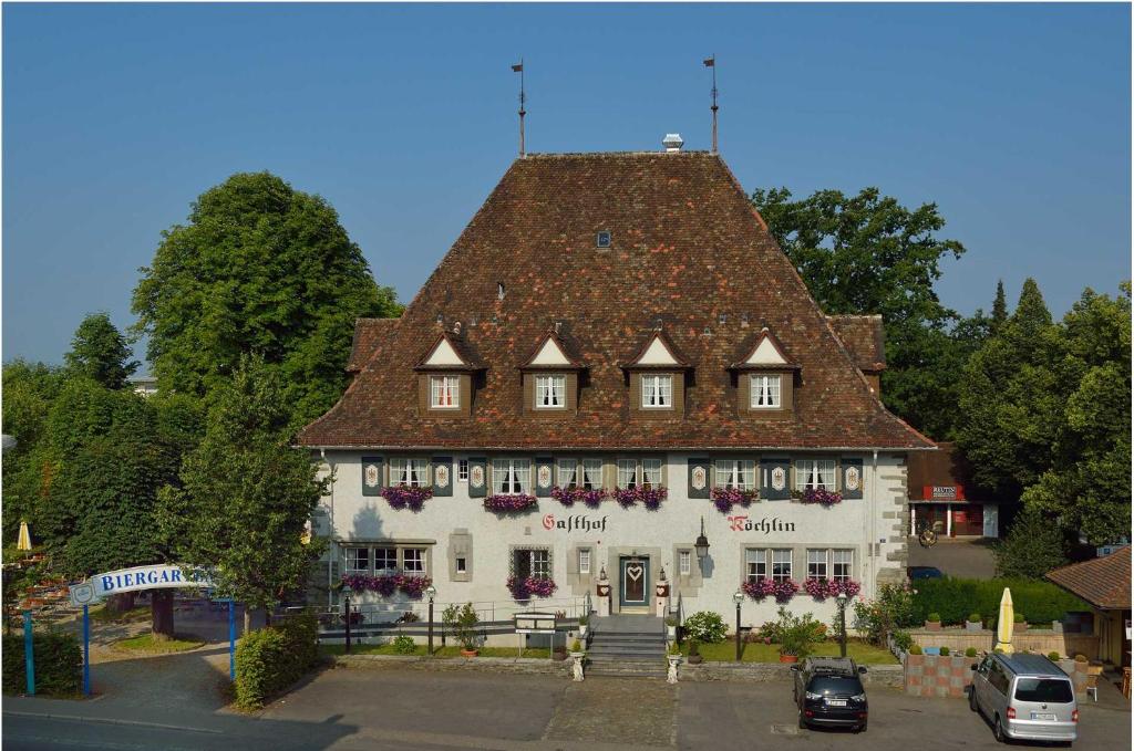 a large white building with a brown roof at Hotel Landgasthof Koechlin in Lindau