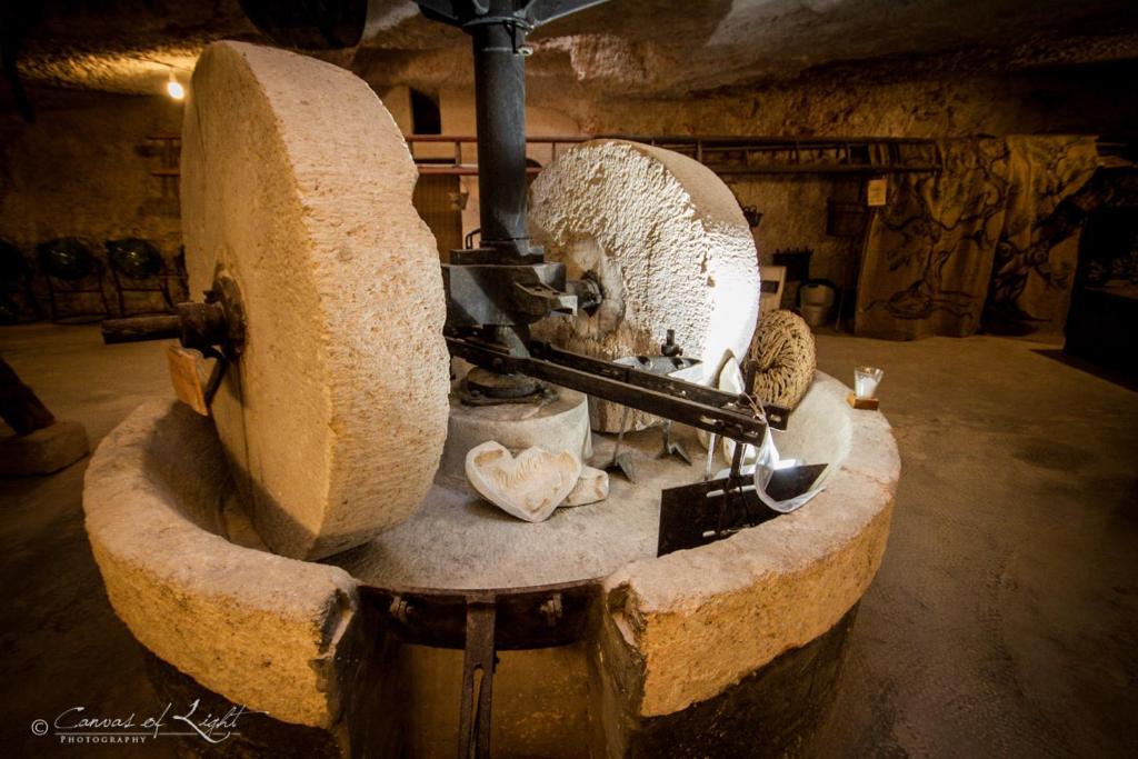 a large stone sculpture in a room with at Masseria Il Frantoio in Ostuni