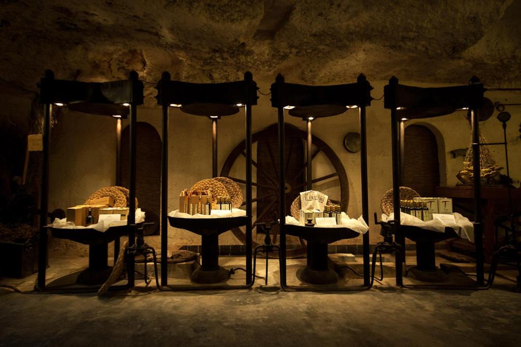 a group of tables with food on them in a room at Masseria Il Frantoio in Ostuni