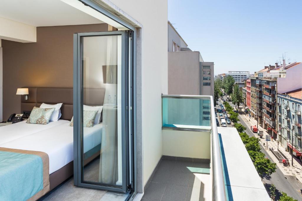 Postel nebo postele na pokoji v ubytování Empire Lisbon Hotel