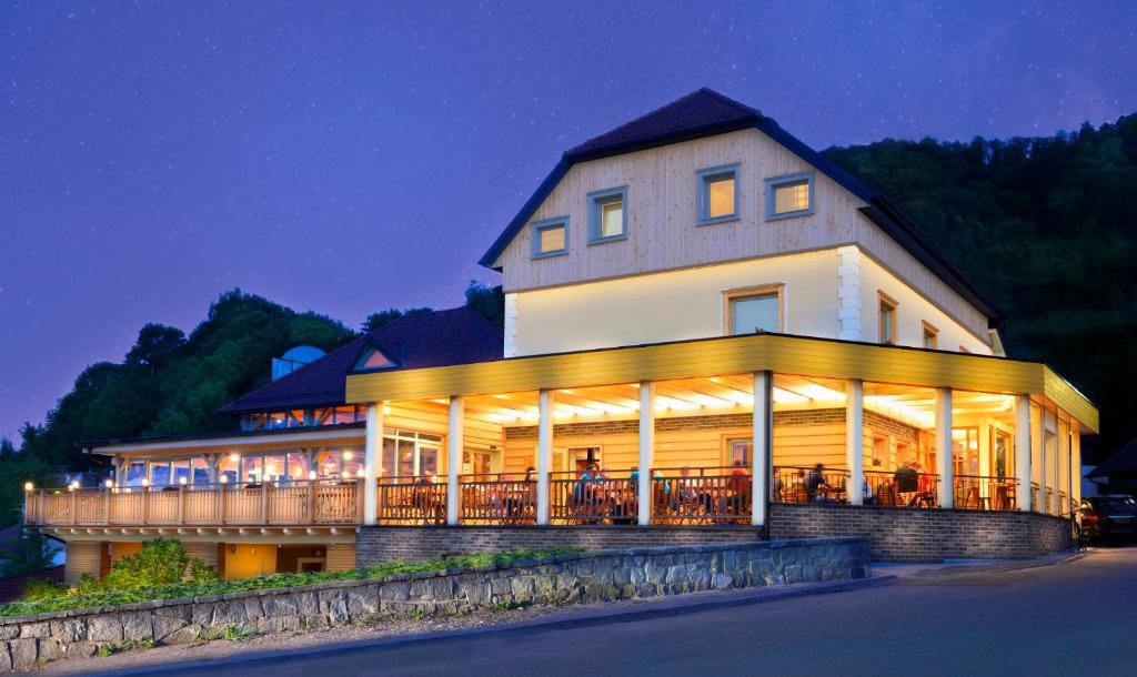 a large building with lights on it at night at Guesthouse Les in Brežice