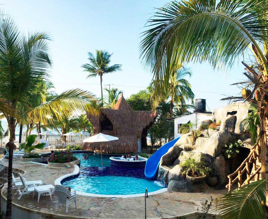 a resort pool with a slide and a water park at Cabañas Aqua Blue in Coveñas