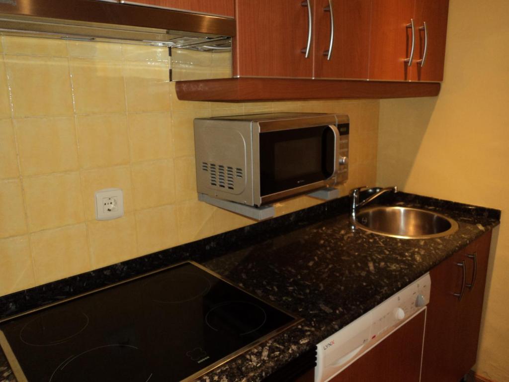 Kuchyň nebo kuchyňský kout v ubytování Apartamentos Casa Rosendo