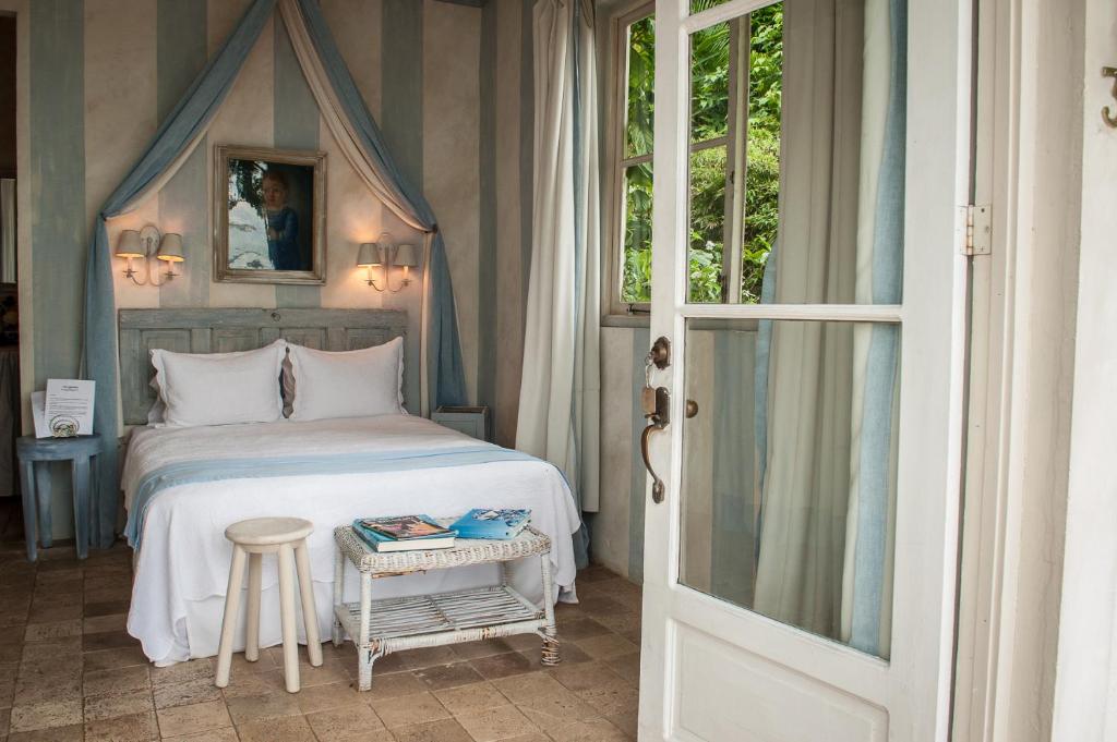 Postel nebo postele na pokoji v ubytování Villa Caprichosa Boutique Hotels