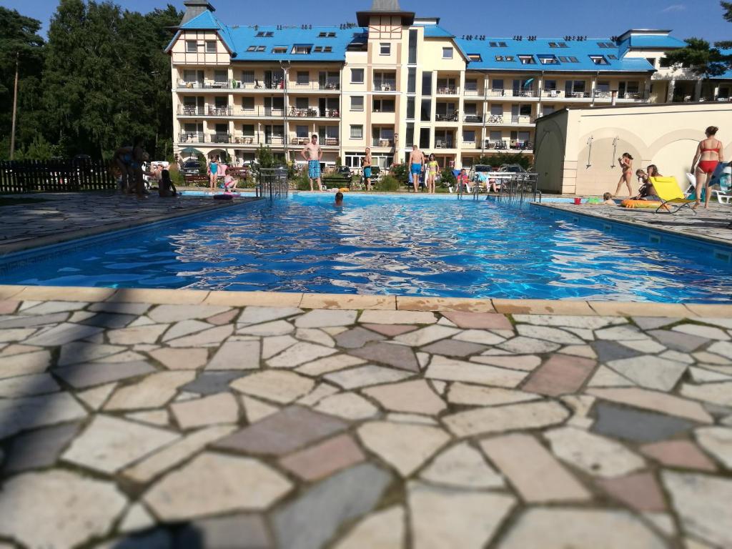a swimming pool in front of a hotel at Dla Ciebie Łukęcin in Łukęcin