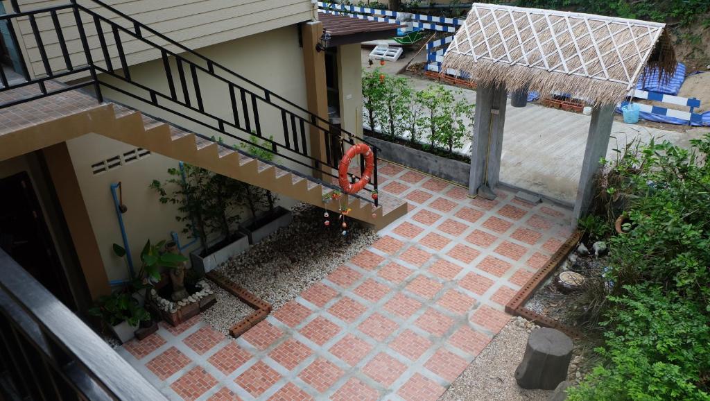 an overhead view of a patio with a staircase and a house at Captan Home in Haad Chao Phao