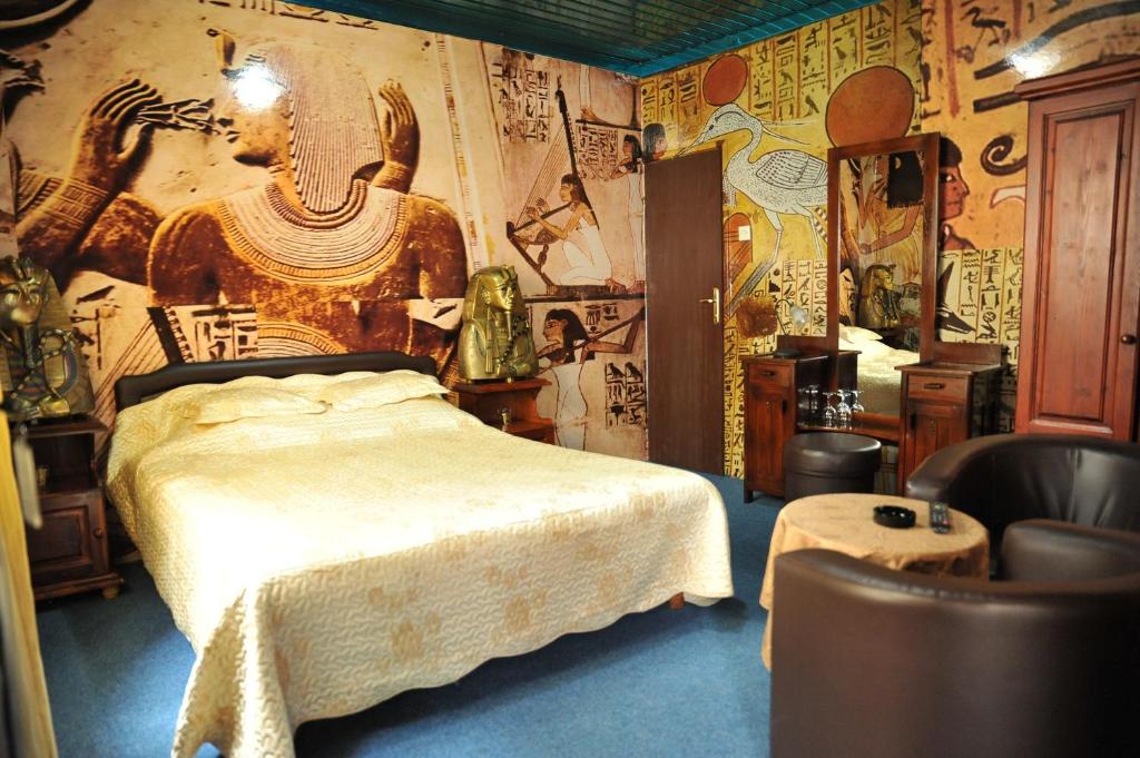 a bedroom with a bed and a wall covered in graffiti at Guesthouse Prenociste Faraon in Pljevlja