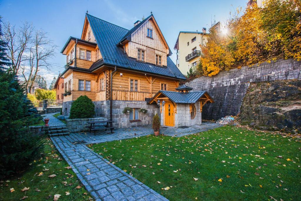 une grande maison en bois avec une cour verdoyante dans l'établissement Goralka, à Szklarska Poręba