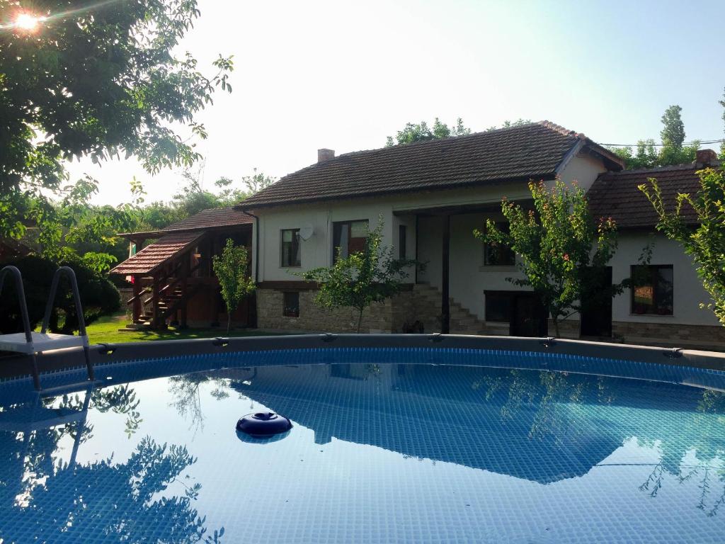 a swimming pool in front of a house at Krai Potoka in Krushuna