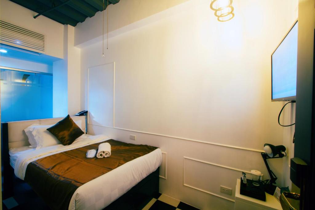 Postel nebo postele na pokoji v ubytování Facade Hotel