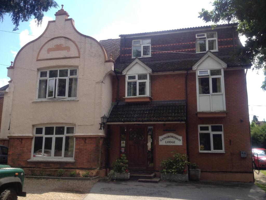 a large brick building with a large window at Gainsborough Lodge in Horley