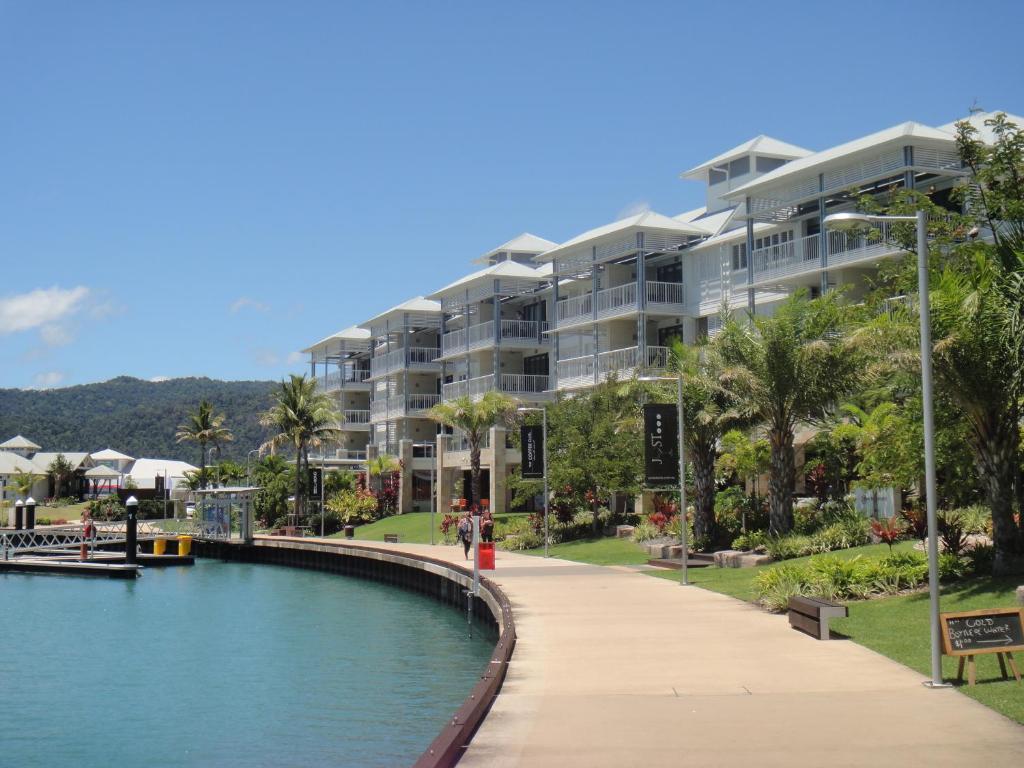 a large body of water surrounded by palm trees at Boathouse Port of Airlie in Airlie Beach