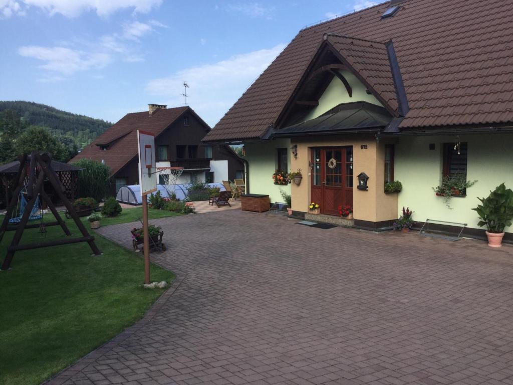 a house with a brick driveway in front of a house at Apartmany Samuel in Rokytnice nad Jizerou