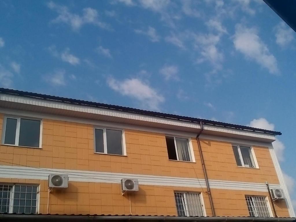 a orange building with windows on the side of it at Hotel Uyut in Bilhorod-Dnistrovsʼkyy