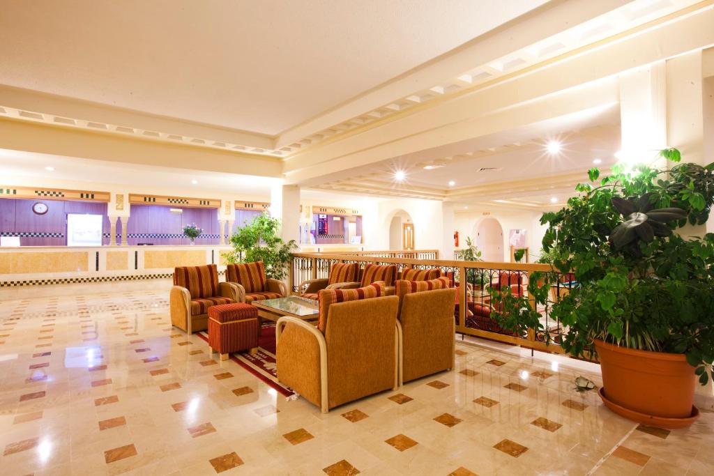 a large lobby with chairs and a waiting room at El Mouradi Cap Mahdia in Mahdia