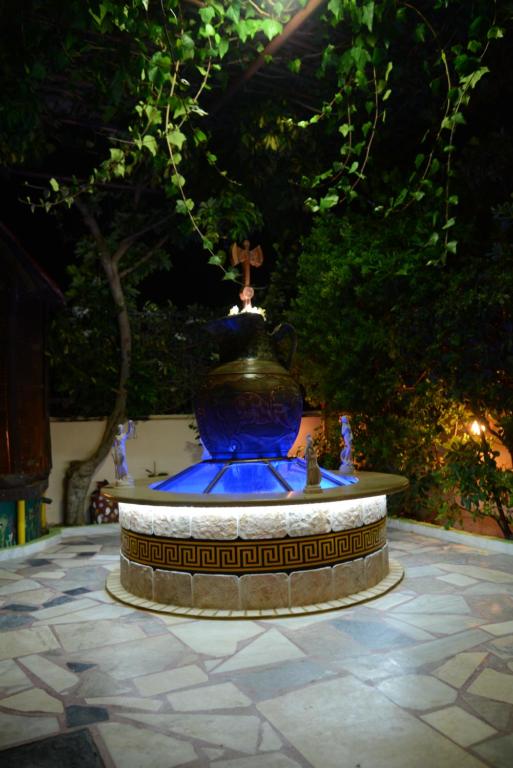 a large blue vase sitting on top of a fountain at Ideal Studios in Amoudara Herakliou