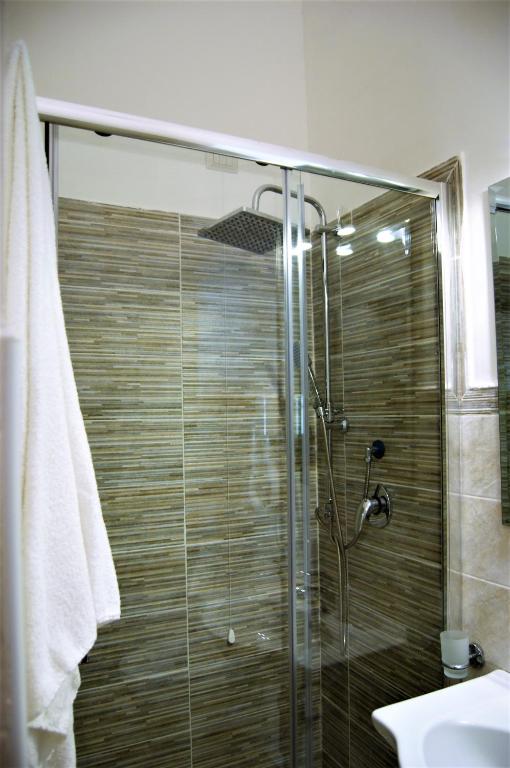 a shower with a glass door in a bathroom at B&B The Tower in Tropea