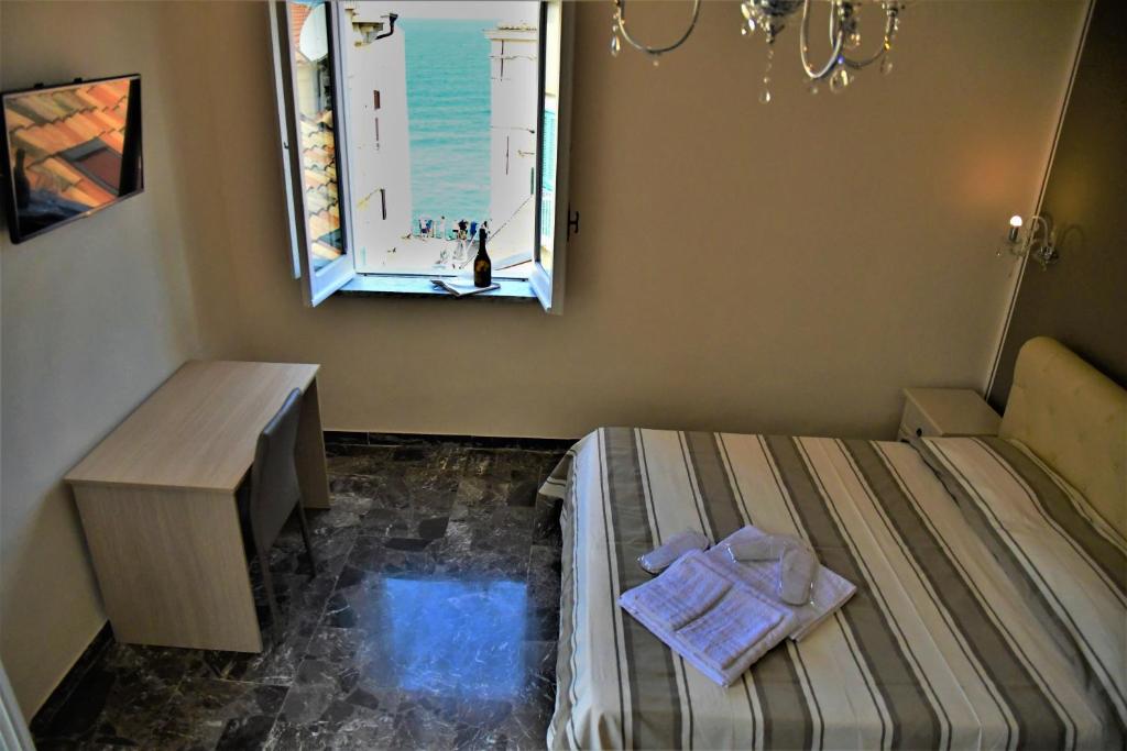 a small room with a bed and a window at B&B The Tower in Tropea