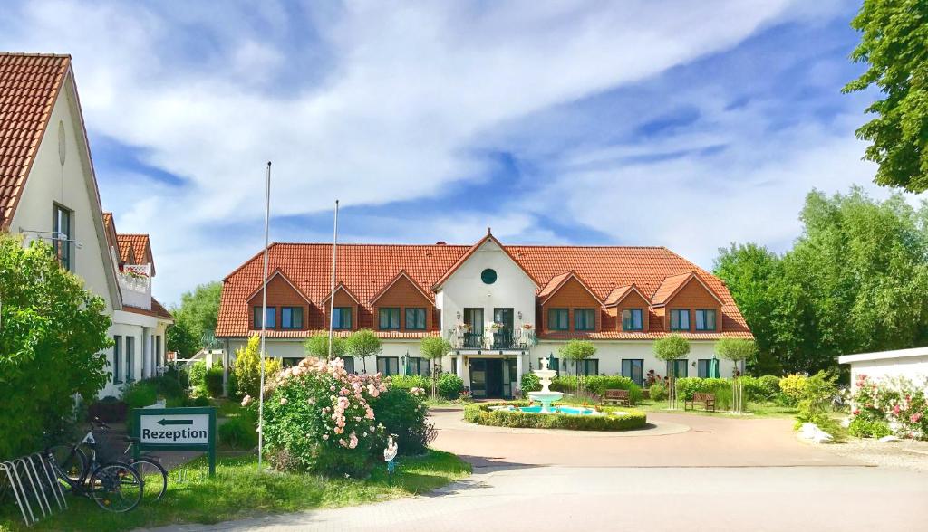 - un groupe de maisons dans une cour avec allée dans l'établissement Hotelanlage Tarnewitzer Hof, à Boltenhagen