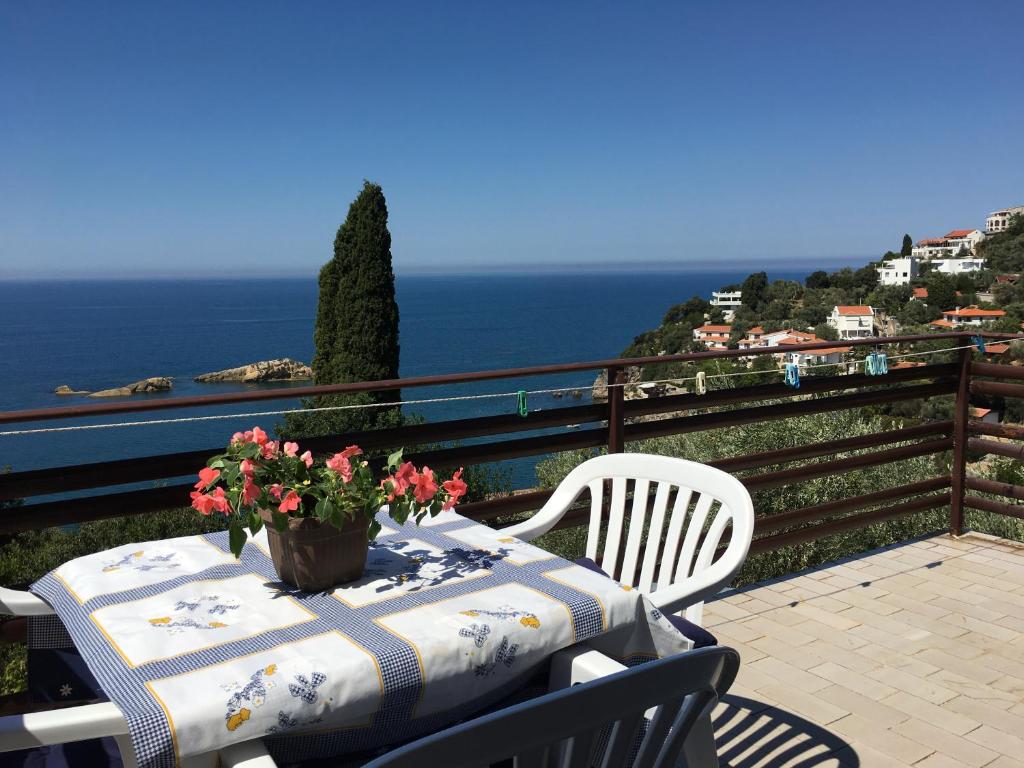 a table with flowers on top of a balcony at Paradiso Apartments - Liman1 in Ulcinj