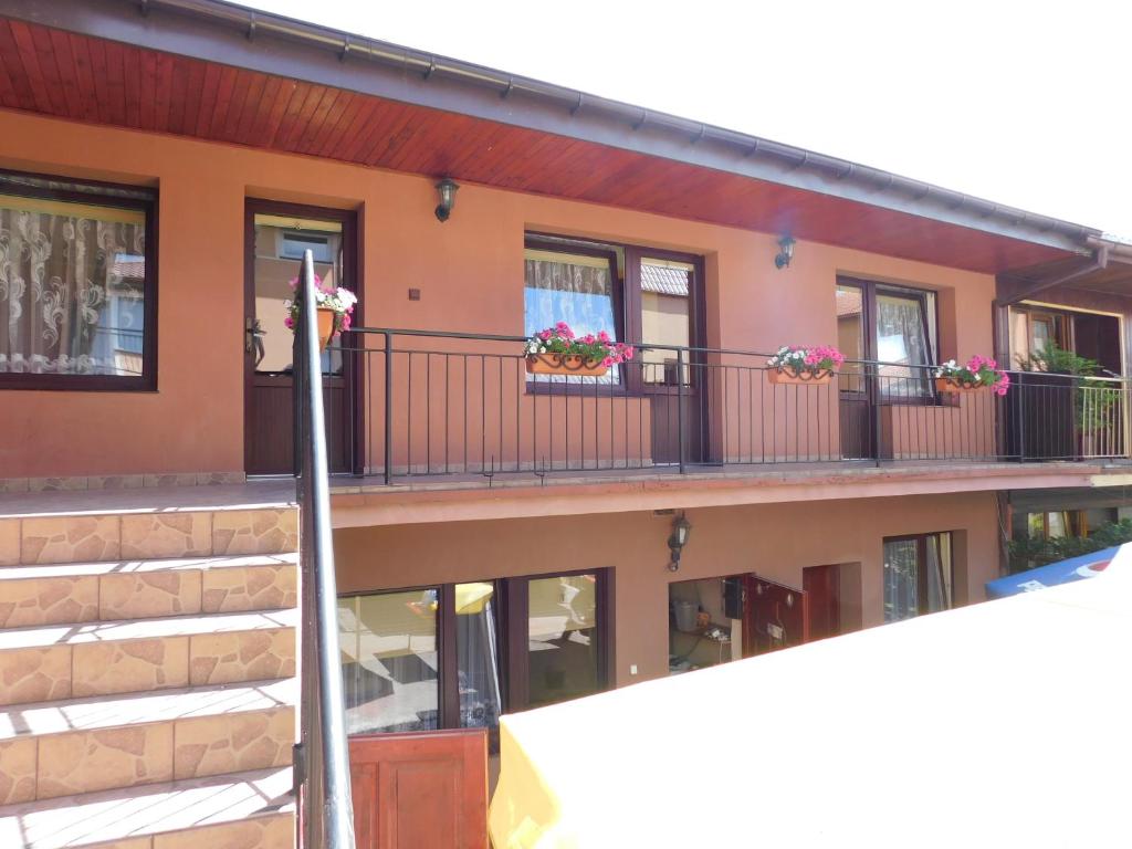 a building with flower boxes on the balconies at Pokoje goscinne Marcin in Łeba