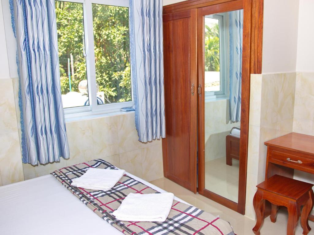 Postel nebo postele na pokoji v ubytování Gia Thanh Phu Quoc Guest House