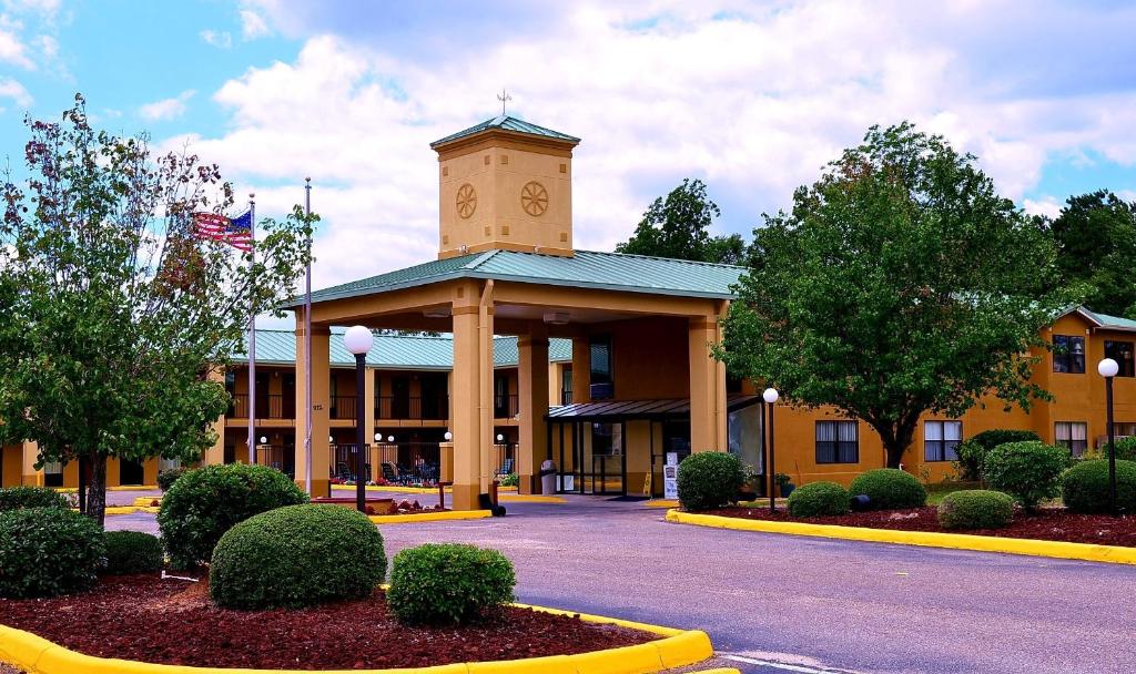 a building with a clock tower on top of it at Executive Inn Opp in Opp