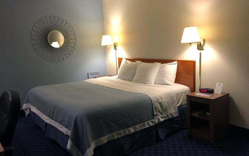 A bed or beds in a room at Mainstreet Inn