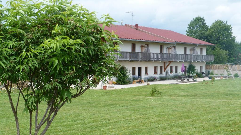 a large white house with a green yard at LA GRANGE DE HAUTE-JOUX in Les Fourgs