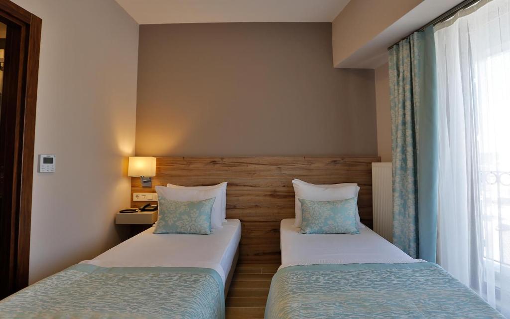 Postel nebo postele na pokoji v ubytování Kule Hotel
